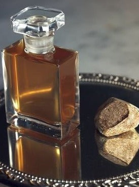 a brown and black clock on a pedestal