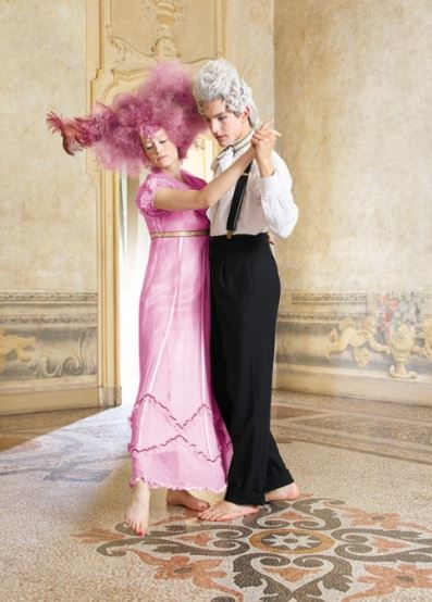 a woman in a pink dress holding a pink flower